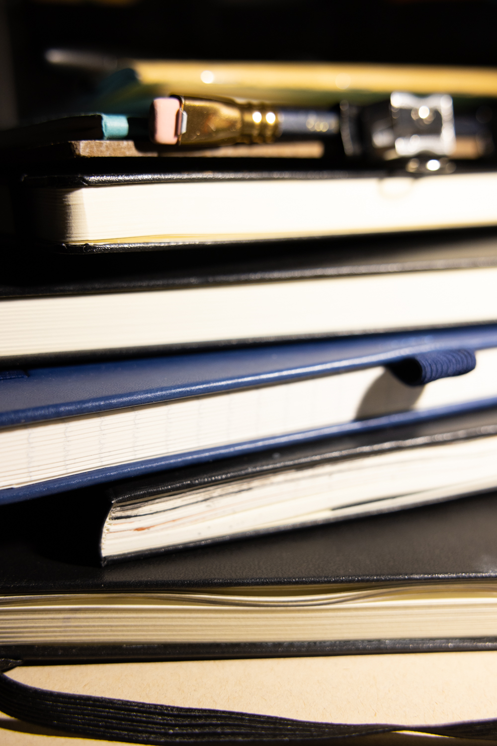 A spread of sketchbooks and drawing papers for gesture drawing practice