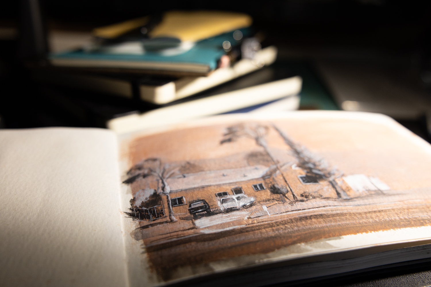 Sketchbooks and drawing paper arranged for gesture drawing practice