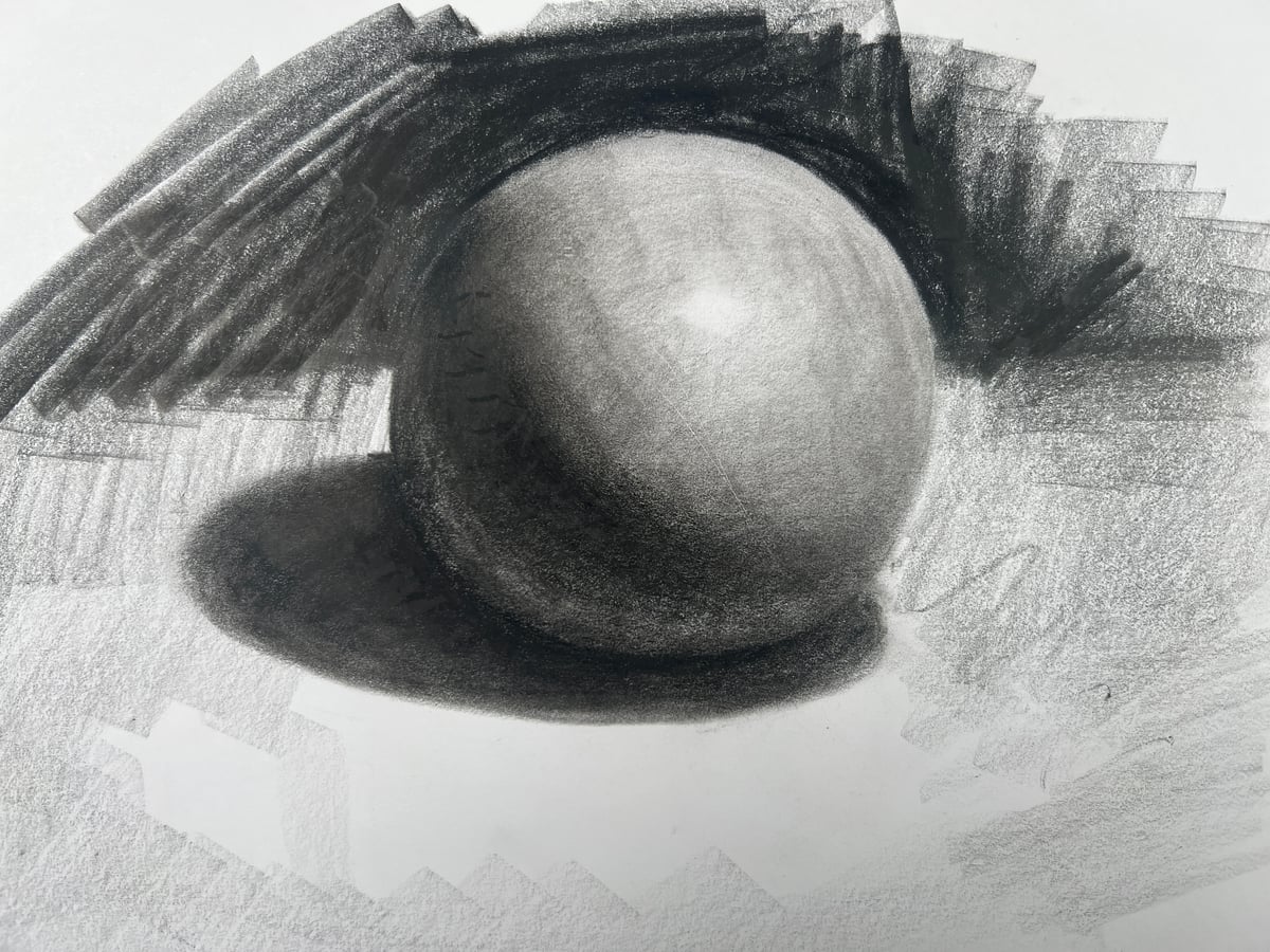 Shaded sphere with a bright highlight, a dark band along the lower left side, and a cast shadow.