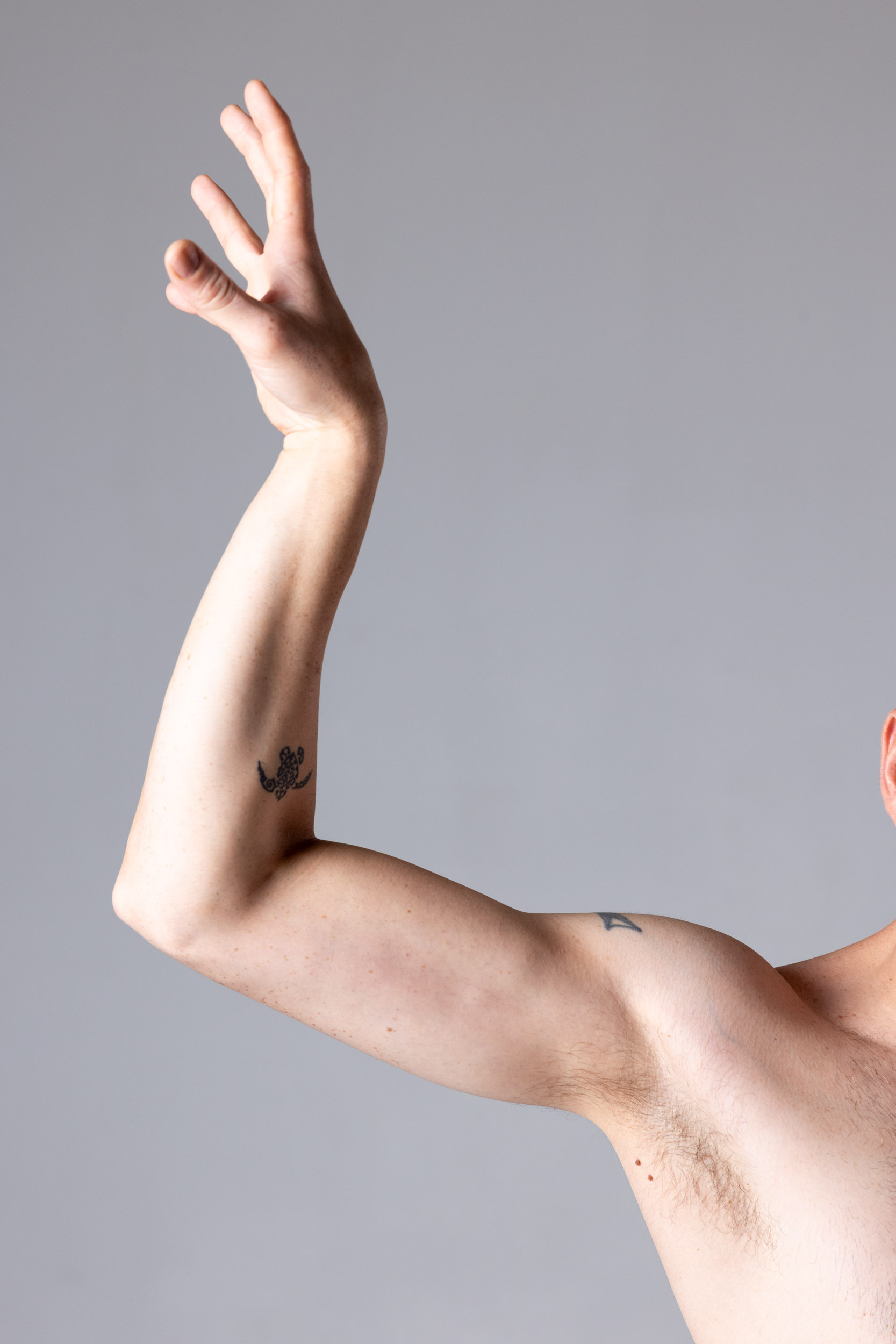 Close-up hand and forearm reference with a lifted wrist and bent fingers