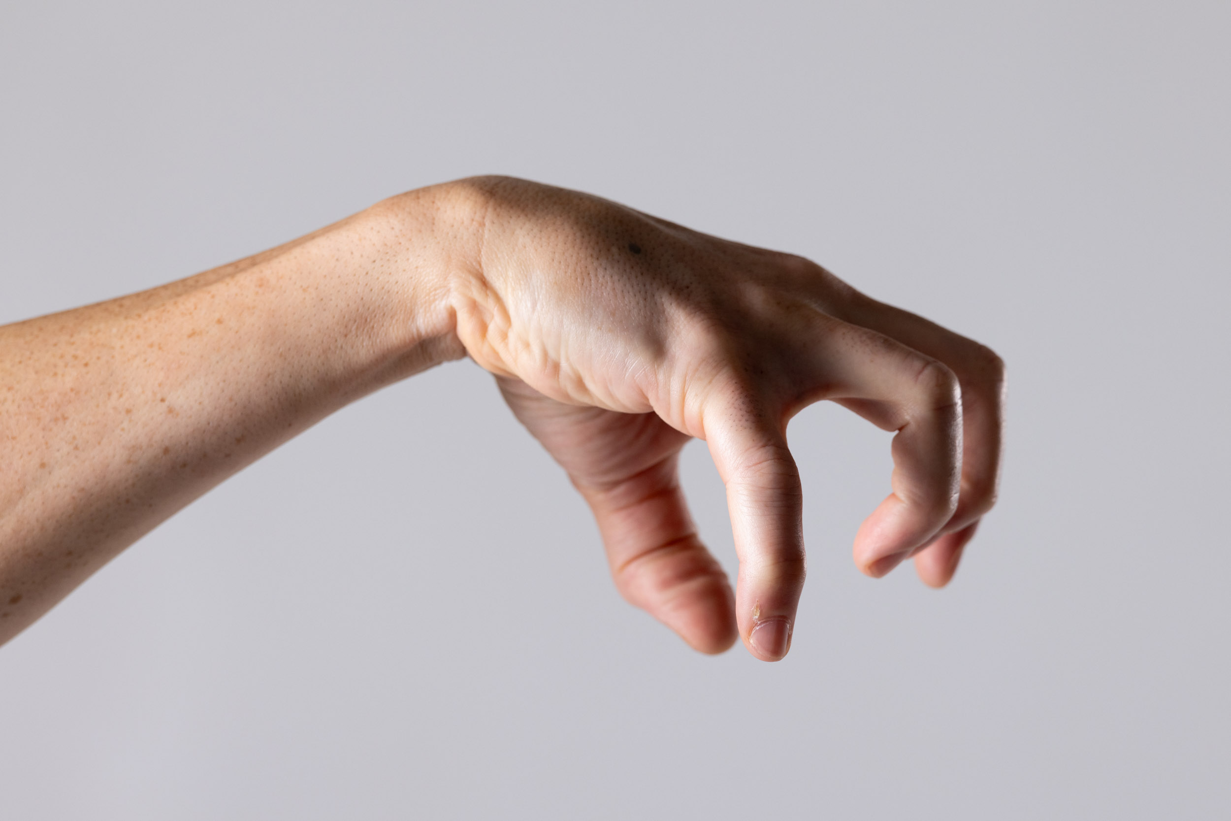 Close-up hand reference crop showing finger length, knuckles, and wrist angle