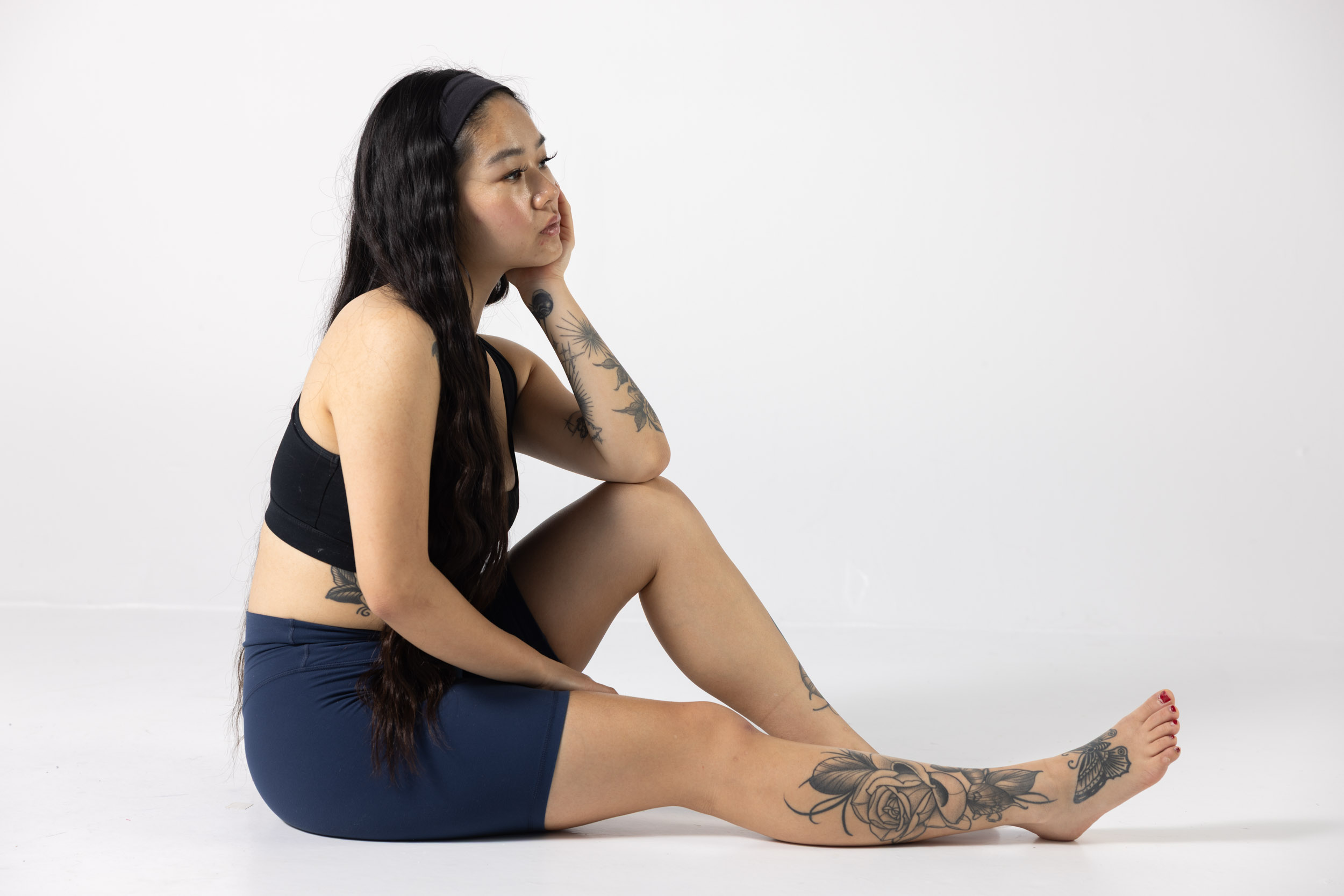 Seated figure reference with a bent knee and side profile for timed drawing practice