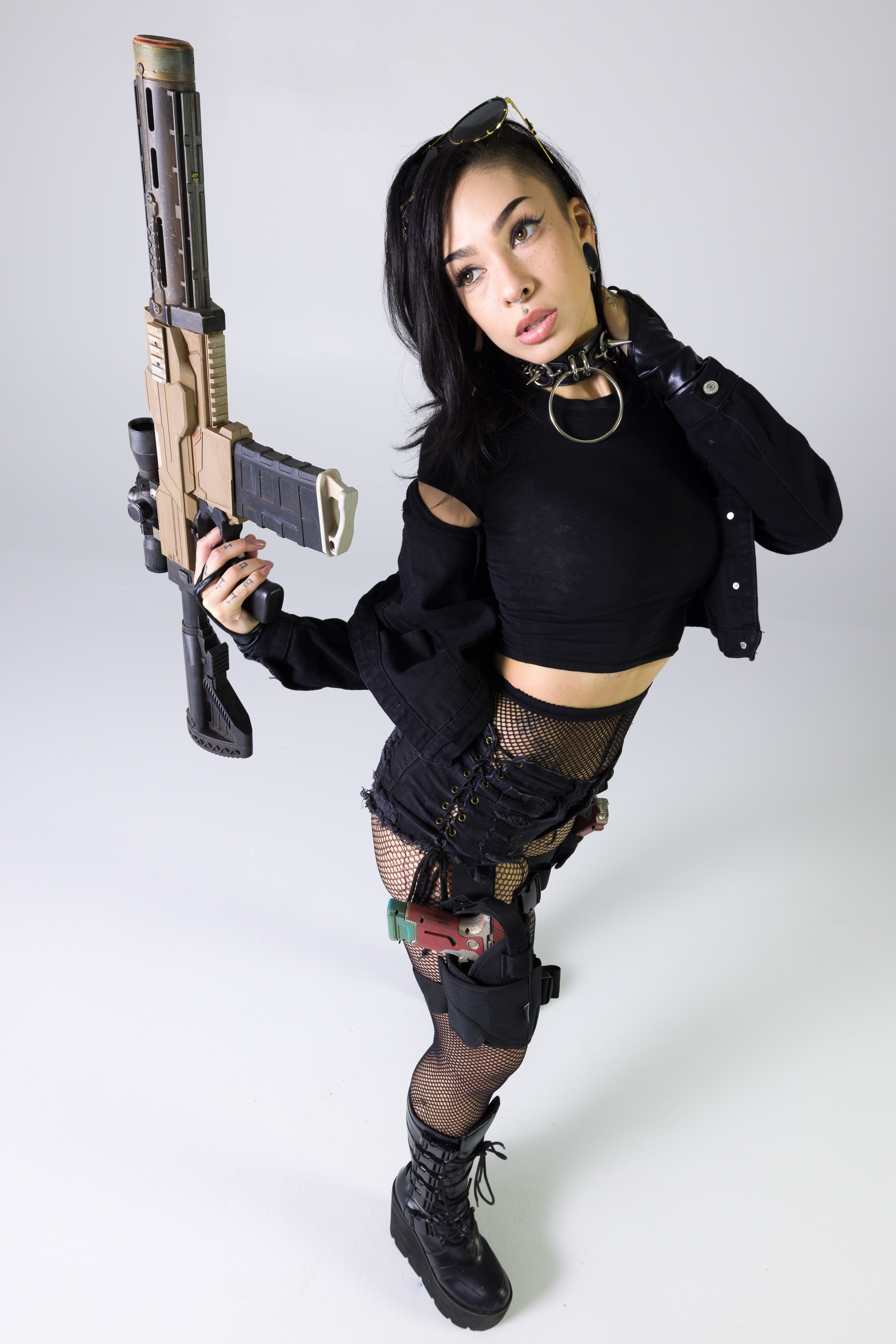 Cyberpunk-inspired standing pose reference holding a long rifle prop while turning the torso