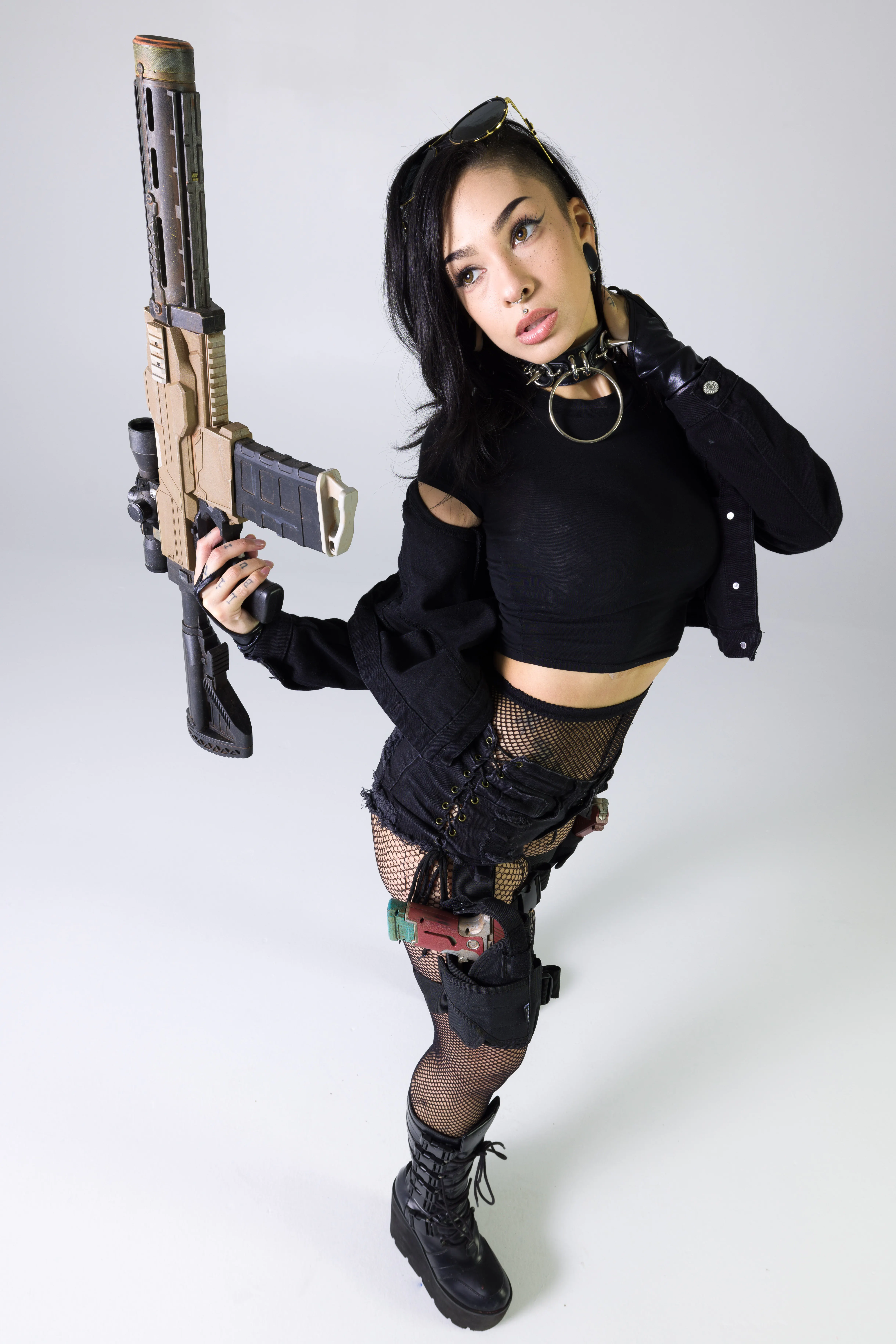 Cyberpunk-inspired standing pose reference holding a long rifle prop while turning the torso