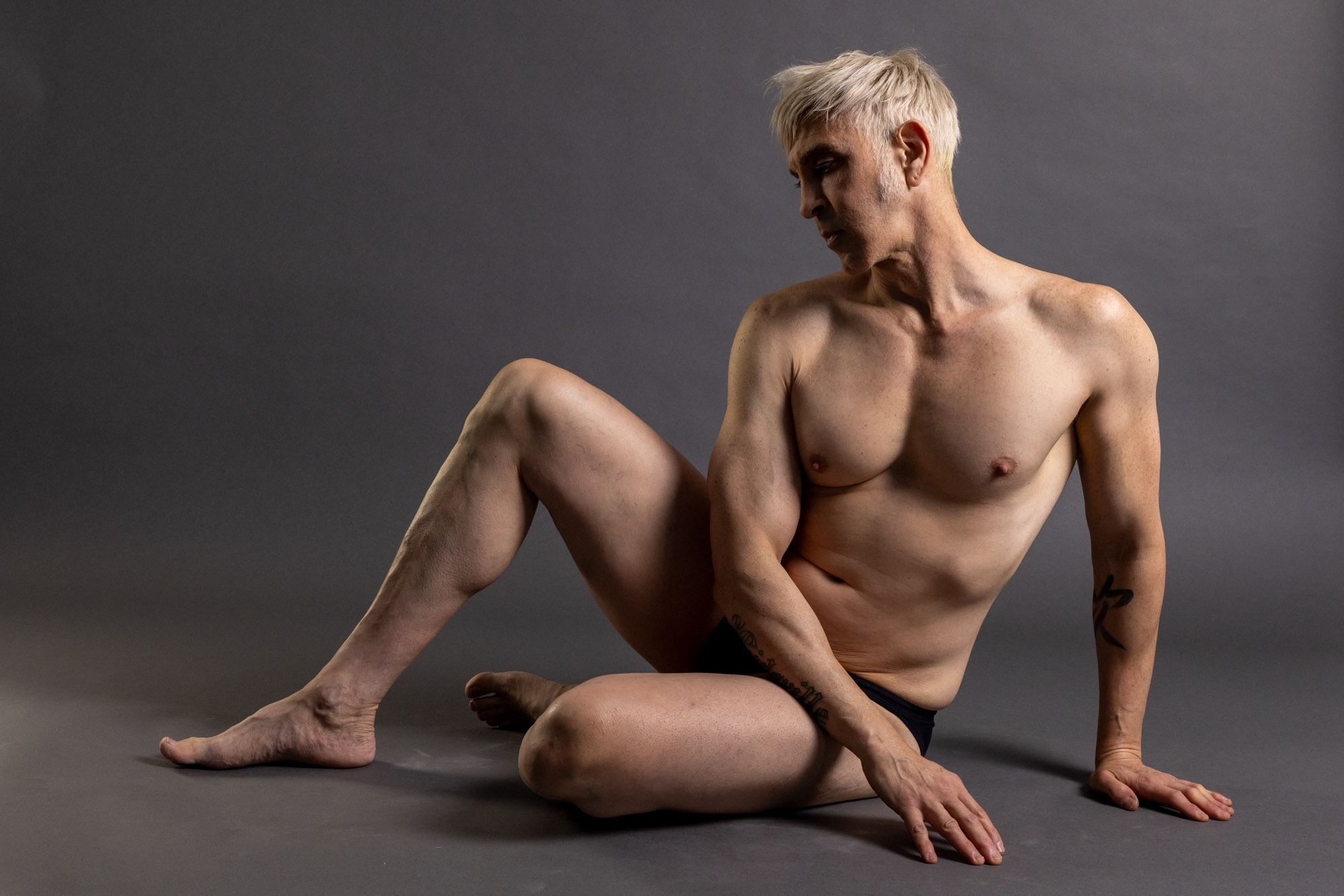Seated model with four measurements comparing shoulder width, shoulder to elbow, knee to ankle, and elbow to wrist.